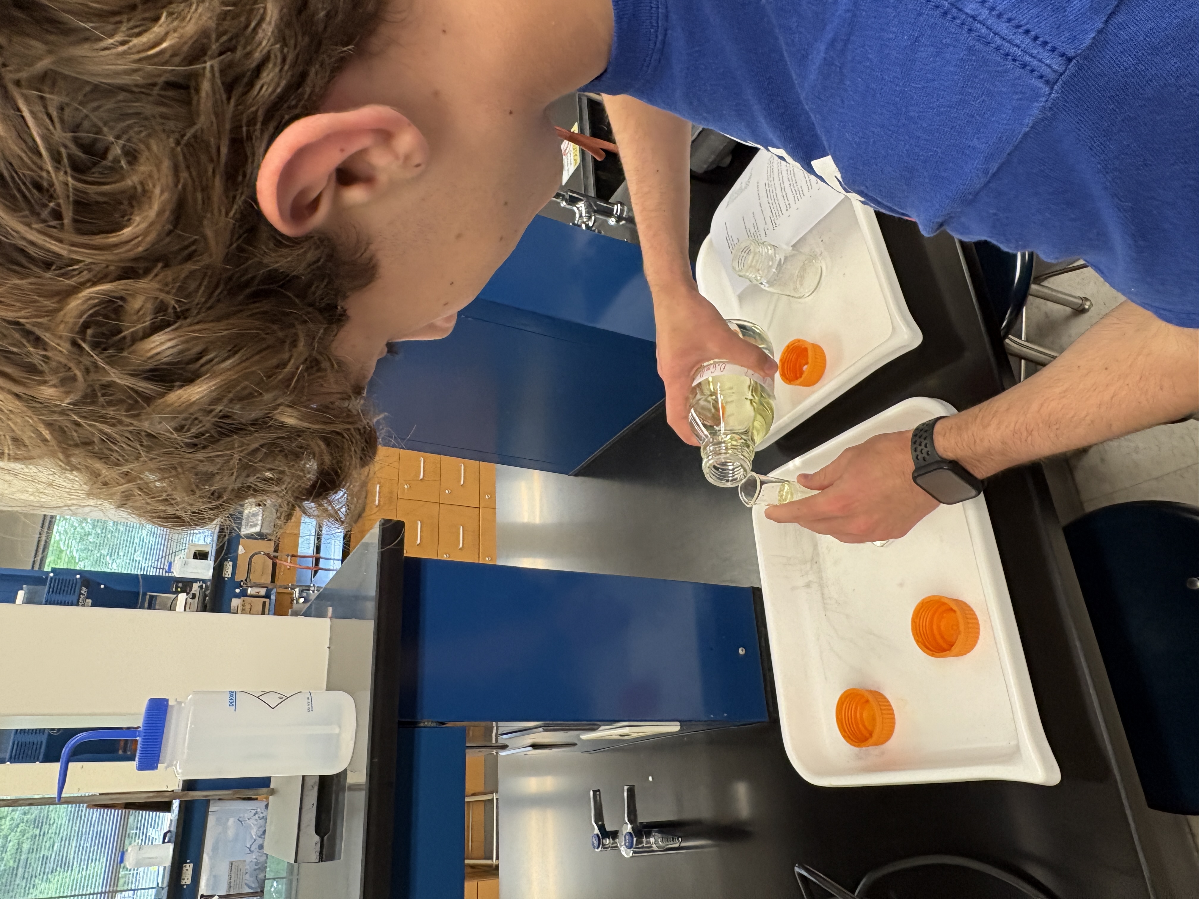 Member preparing a solution during a club meeting